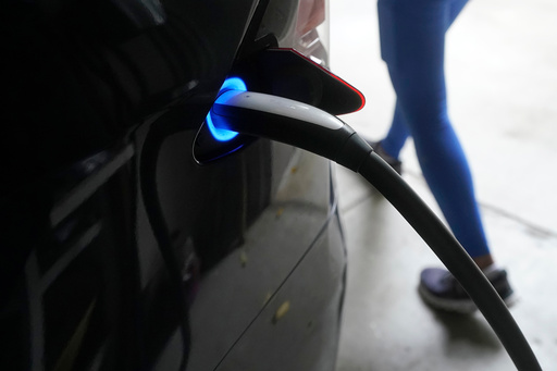 FILE - A Tesla car charges at a home in San Francisco, Aug. 25, 2022. (AP Photo/Jeff Chiu, File) FILE - A Tesla car charges at a home in San Francisco, Aug. 25, 2022. (AP Photo/Jeff Chiu, File)