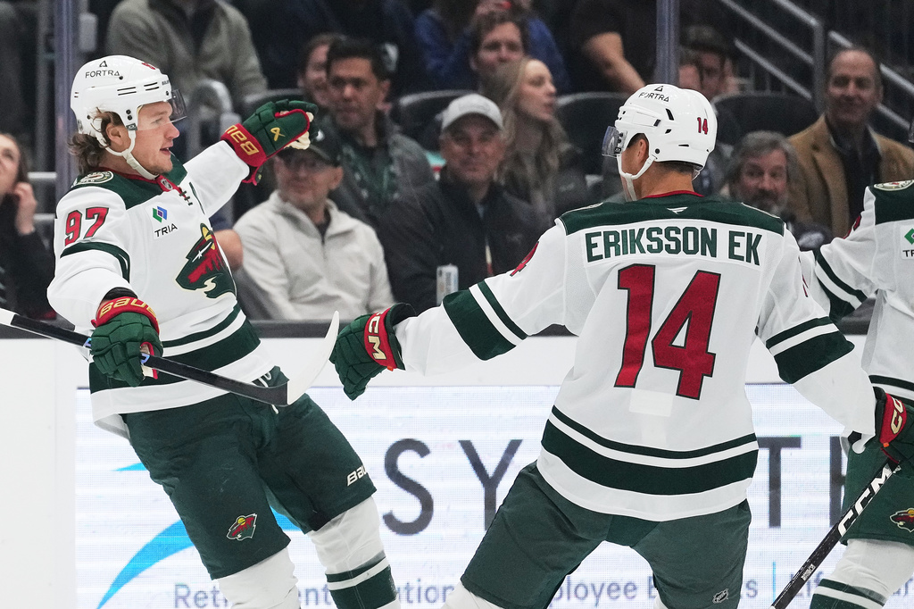 Minnesota Wild left wing Kirill Kaprizov (97) celebrates scoring against the Seattle Kraken with center Joel Eriksson Ek (14) during the first period of an NHL hockey game Saturday, Oct. 24, 2026, in Seattle. (AP Photo/Lindsey Wasson)