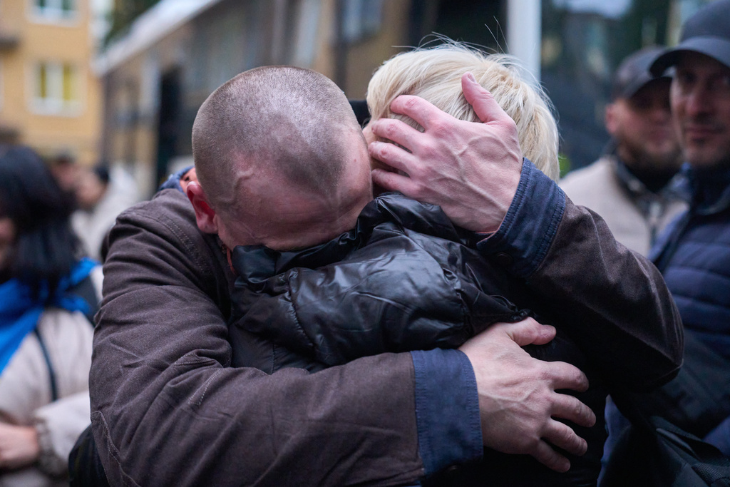 A soldier returning from Russian captivity hugs his wife during a POW exchange between Russia and Ukraine in Chernyhiv region, Ukraine, Thursday, Oct. 2, 2025. (AP Photo/Efrem Lukatsky)
