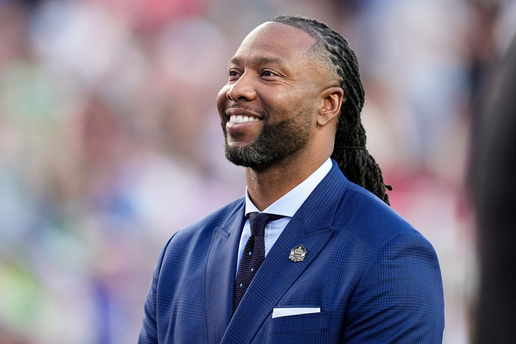 FILE - Former NFL player Larry Fitzgerald stands on the field for a tribute during the first half of the NFL Super Bowl 60 football game between the New England Patriots and the Seattle Seahawks, Feb. 8, 2026, in Santa Clara, Calif. (AP Photo/Julio Cortez, File)