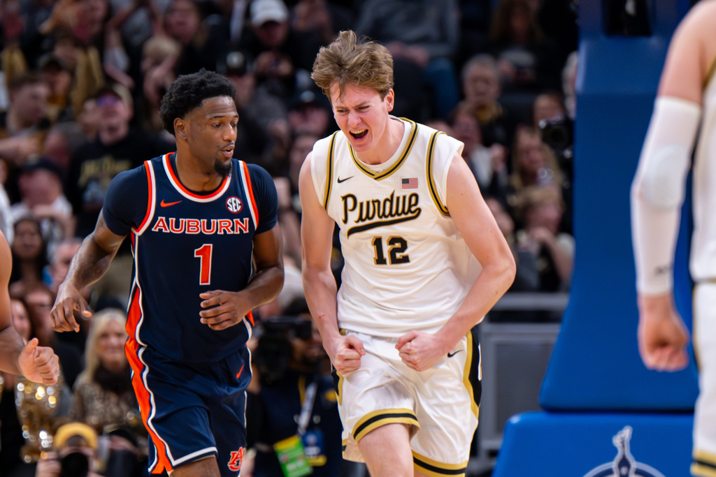 Purdue center Daniel Jacobsen (12) reacts after scoring during the second half of an NCAA college basketball game against Auburn, Saturday, Dec. 20, 2025, in Indianapolis (AP Photo/Doug McSchooler)