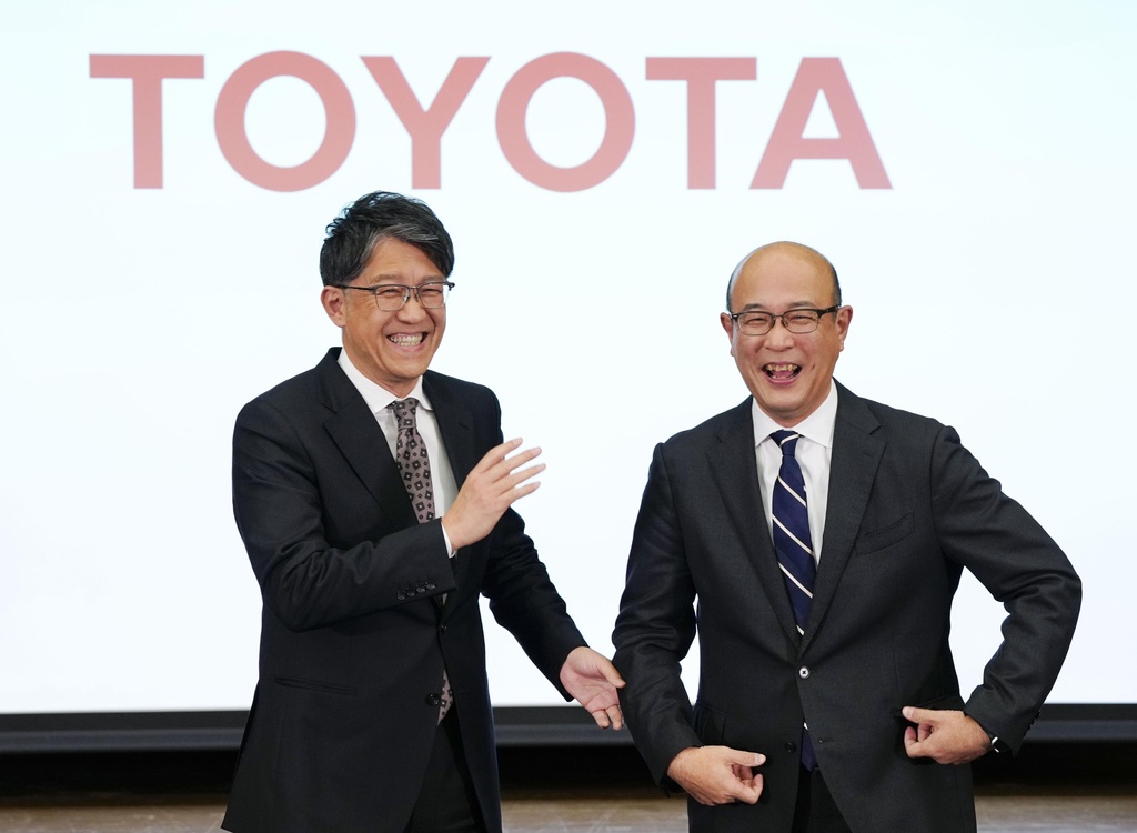 Kenta Kon, right, an executive officer who has been named the next president of Toyota Motor Corp., poses for a photo with current President Koji Sato, left, in Tokyo on Friday, Feb. 6, 2026. (Yohei Fukai/Kyodo News via AP)