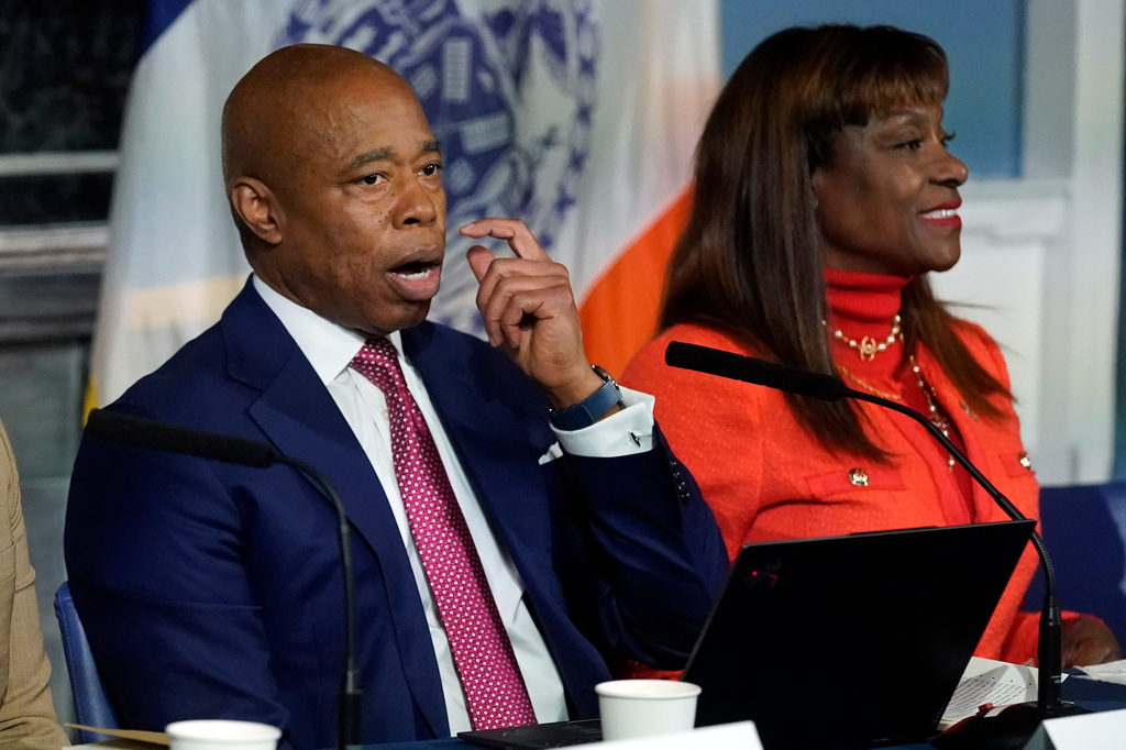 FILE - New York Mayor Eric Adams, accompanied by Ingrid Lewis-Martin, his chief advisor, responds to questions during a news conference at New York's City Hall, Nov. 14, 2023. (AP Photo/Richard Drew, File)