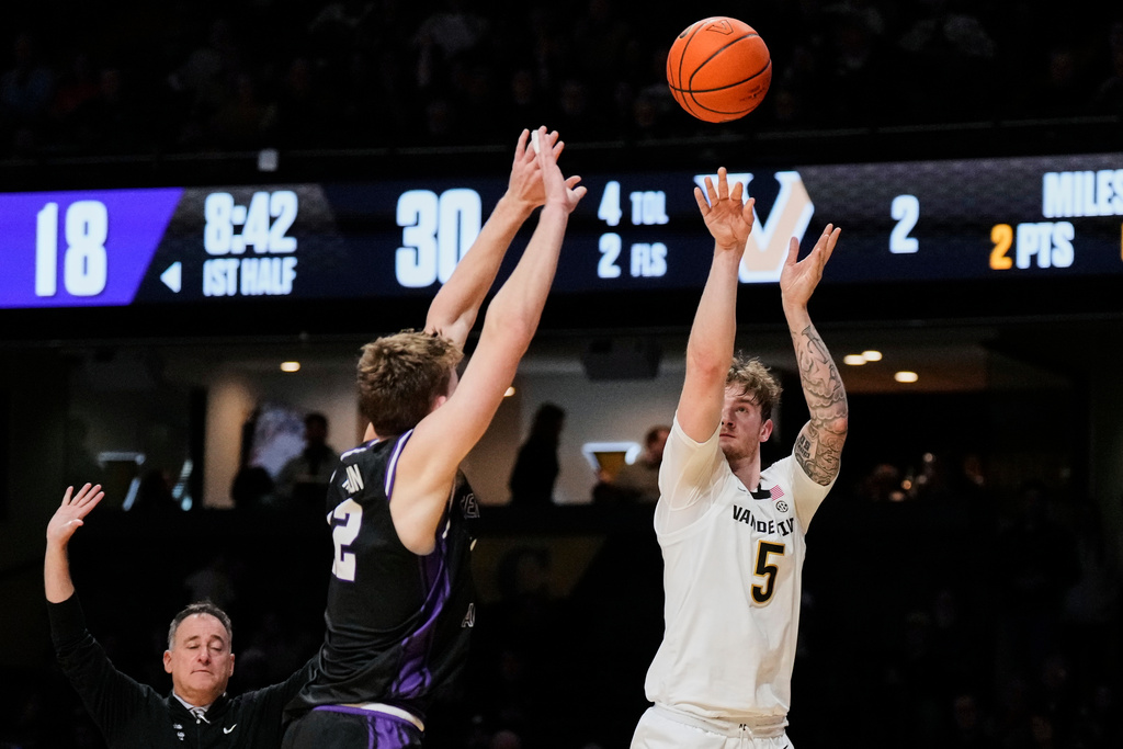 Vanderbilt forward Tyler Nickel (5) shoots the ball over Central Arkansas guard Ty Robinson (12) during the first half of an NCAA college basketball game Saturday, Dec. 13, 2025, in Nashville, Tenn. (AP Photo/George Walker IV)