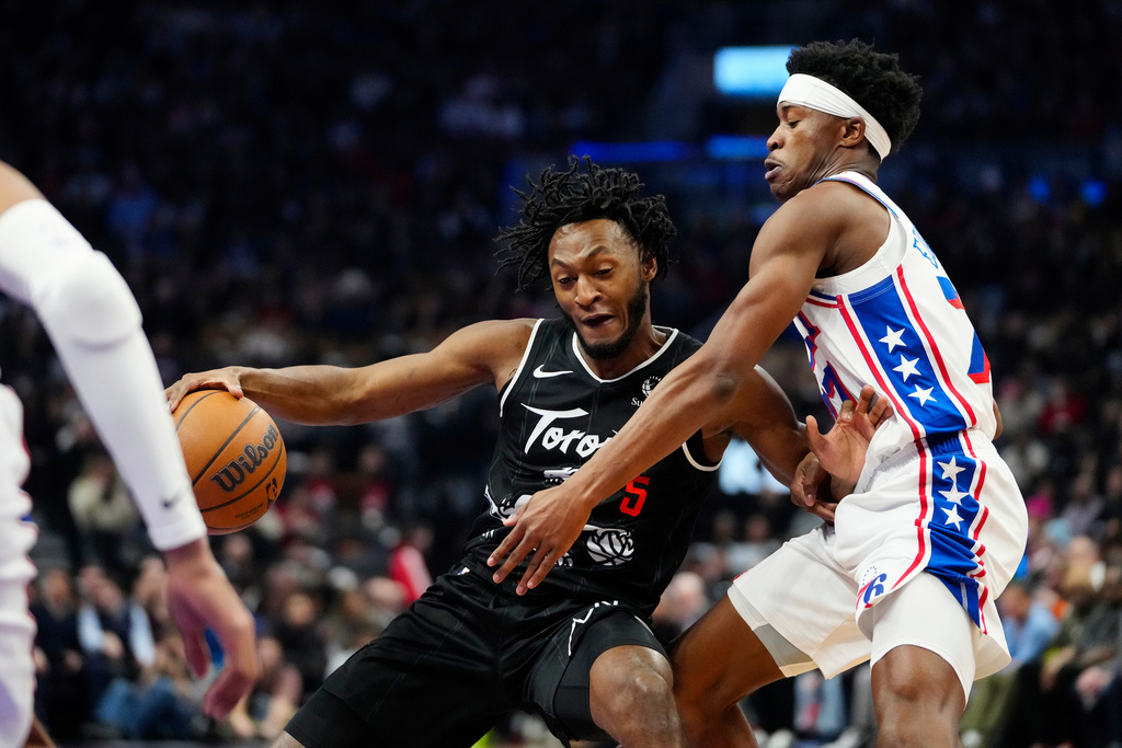 Toronto Raptors guard Immanuel Quickley (5) moves the ball under pressure from Philadelphia 76ers guard Vj Edgecombe during the first half of an NBA basketball game in Toronto, Monday, Jan. 12, 2026. (Frank Gunn/The Canadian Press via AP)
