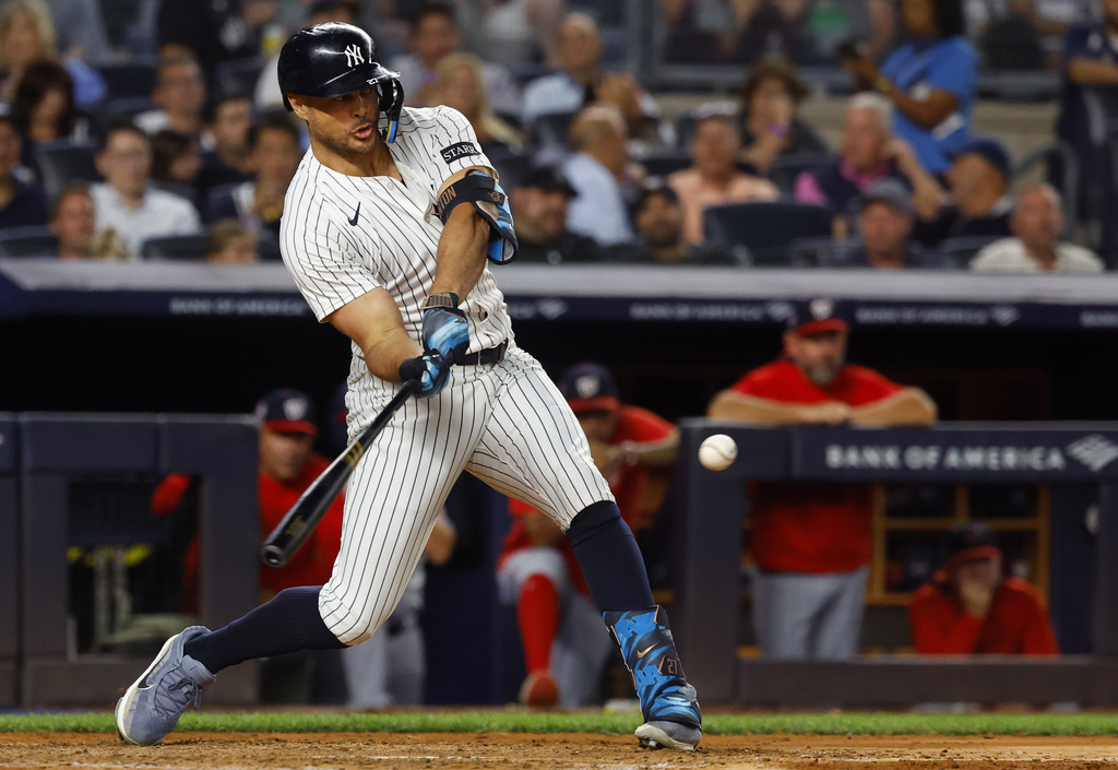New York Yankees' Giancarlo Stanton hits two run home run during the sixth inning of a baseball game against the Washington Nationals, Tuesday, Aug. 26, 2025, in New York. (AP Photo/Noah K. Murray)