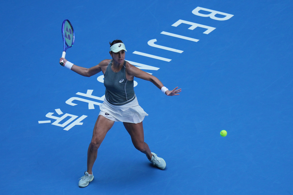 Belinda Bencic, of Switzerland plays a forehand return to Coco Gauff, of the United States during the women's singles match of the China Open tennis tournament, in Beijing, Tuesday, Sept. 30, 2025. (AP Photo/Andy Wong)
