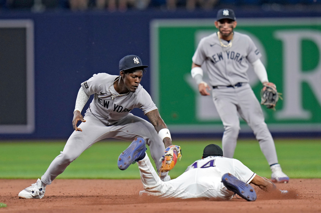New York Yankees second baseman Jazz Chisholm Jr. tags out Tampa Bay Rays' Chandler Simpson (14) attempting to steal second base during the eighth inning of a baseball game Friday, April 10, 2026, in St. Petersburg, Fla. (AP Photo/Chris O'Meara)