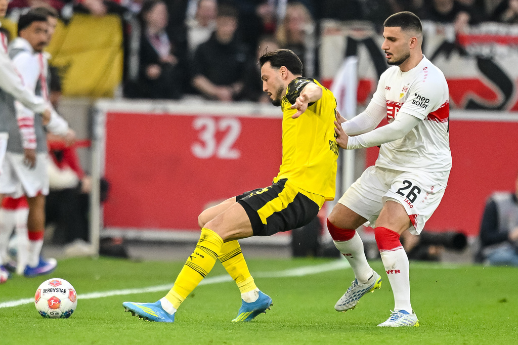 Stuttgart's Deniz Undav, right, and Dortmund's Ramy Bensebaïni in action during a German Bundesliga soccer match between VfB Stuttgart and Borussia Dortmund in Stuttgart, Germany, Saturday, April 4, 2026. (Harry Langer/dpa via AP)