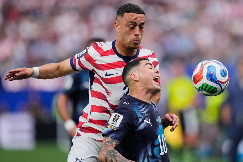 Paraguay's Miguel Almiron, right, and United States' Sergino Dest battle for the ball during the World Cup Group D soccer match between the United States and Paraguay in Inglewood, Calif., near Los Angeles, Friday, June 12, 2026. (AP Photo/Mark J. Terrill)