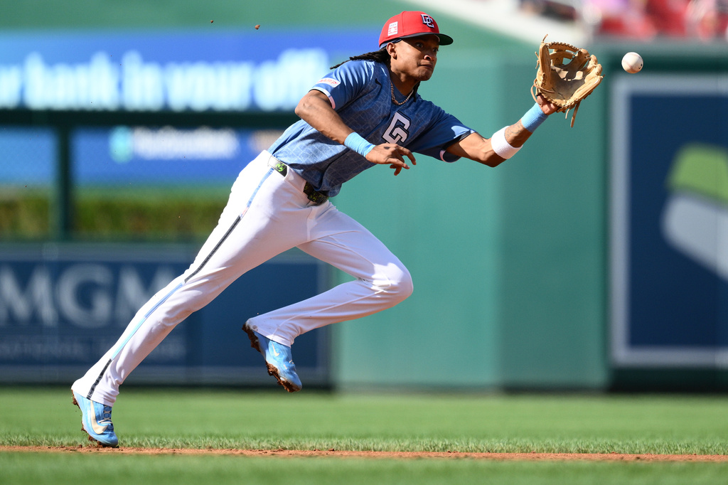 Washington Nationals shortstop CJ Abrams fields a ground ball ht by Arizona Diamondbacks' Ryan Waldschmidt for a single during the third inning of a baseball game, Saturday, July 25, 2026, in Washington. (AP Photo/Nick Wass)