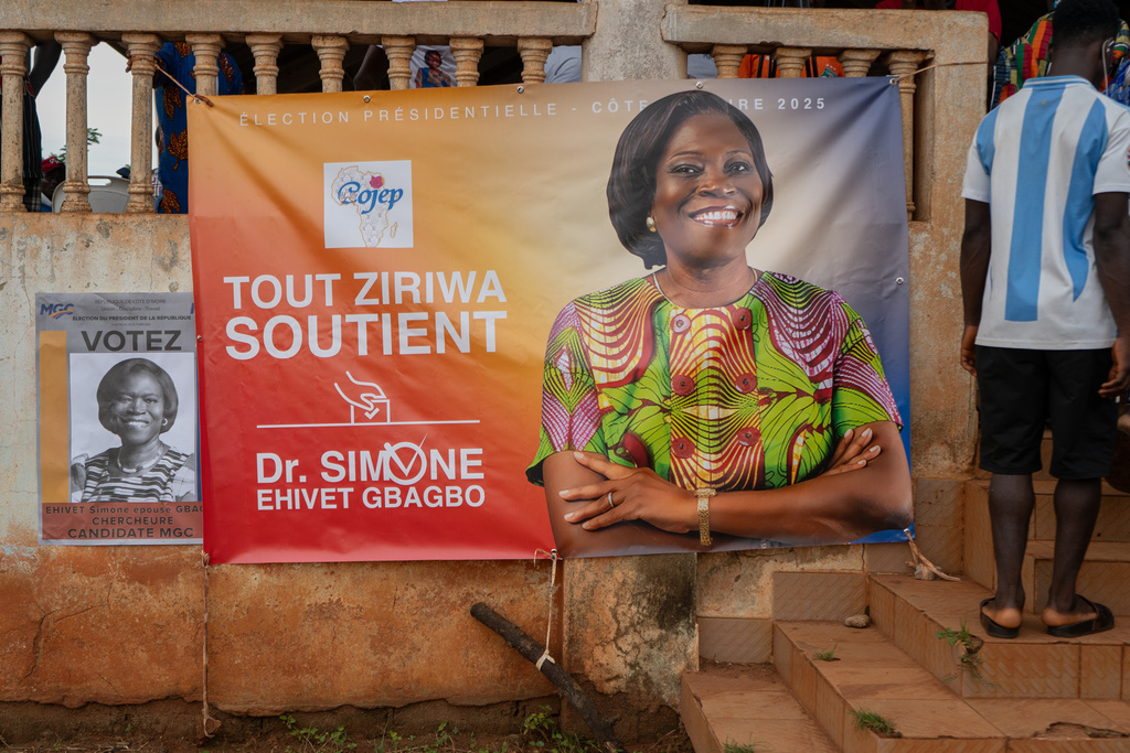A campaign banner of presidential candidate Simone Ehivet Gbagbo is displayed on a wall during a campaign rally in Guiberoua, Ivory Coast, Tuesday, Oct 14, 2025 (AP Photo/ Marine Jeannin)