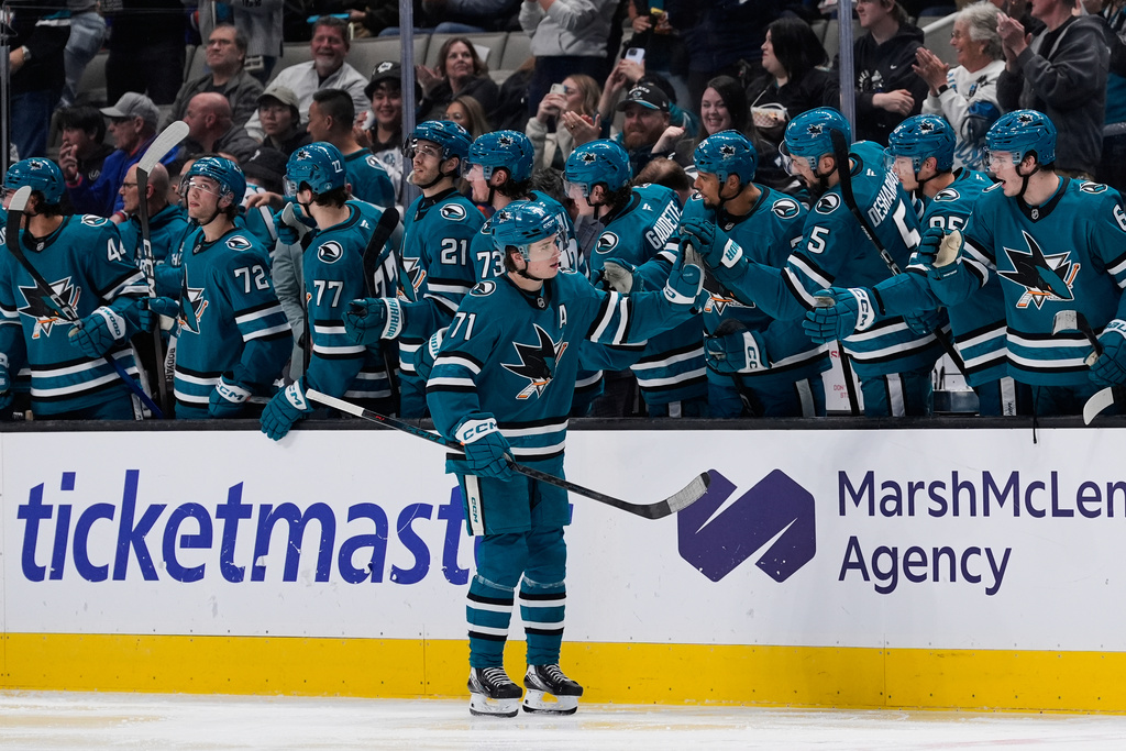 San Jose Sharks center Macklin Celebrini (71) celebrates with teammates after scoring a goal during the second period of an NHL hockey game against the New York Islanders, Saturday, March 7, 2026, in San Jose, Calif. (AP Photo/Godofredo A. Vásquez)