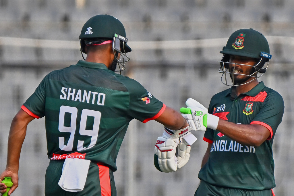 Bangladesh's Najmul Hossain Shanto congratulate Tanzid Hasan Tamim, right fir scoring fifty runs during the second one day international cricket match between Bangladesh and New Zealand in Mirpur, Bangladesh, Monday, April 20, 2026. (AP Photo/Mosaraf Hossain)