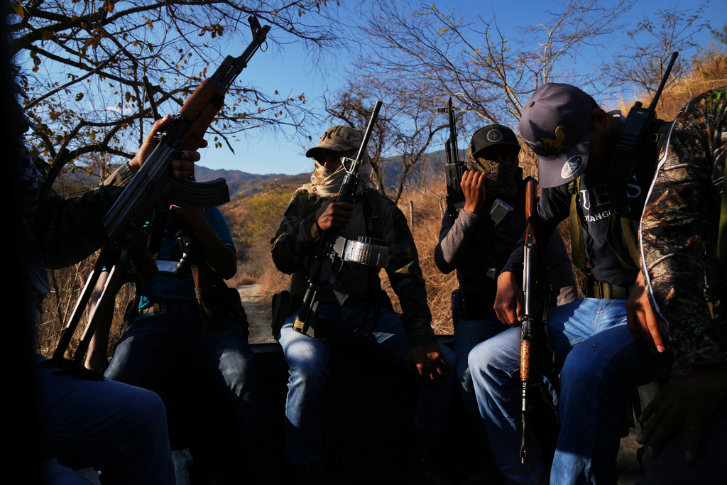 Members of a local self-defense group formed by residents in response to cartel violence patrol in Guajes de Ayala, Mexico, Tuesday, March 10, 2026. (AP Photo/Marco Ugarte)