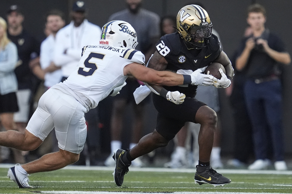 Vanderbilt running back Sedrick Alexander (28) runs the ball past Charleston Southern linebacker Steve Zayachkowsky (5) during the second half of an NCAA college football game Saturday, Aug. 30, 2025, in Nashville, Tenn. (AP Photo/George Walker IV)