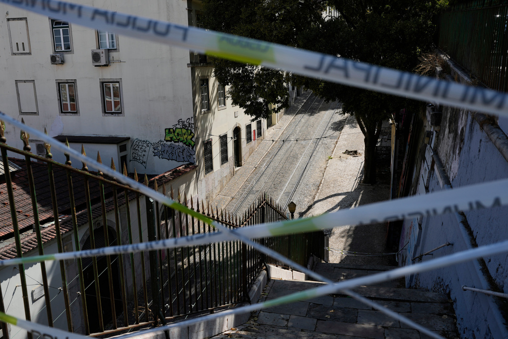 FILE - Police tape cordons-off the access to the tracks of the Gloria funicular, a tourist streetcar that derailed and crashed, in Lisbon, Sept. 5, 2025. (AP Photo/Armando Franca, File)