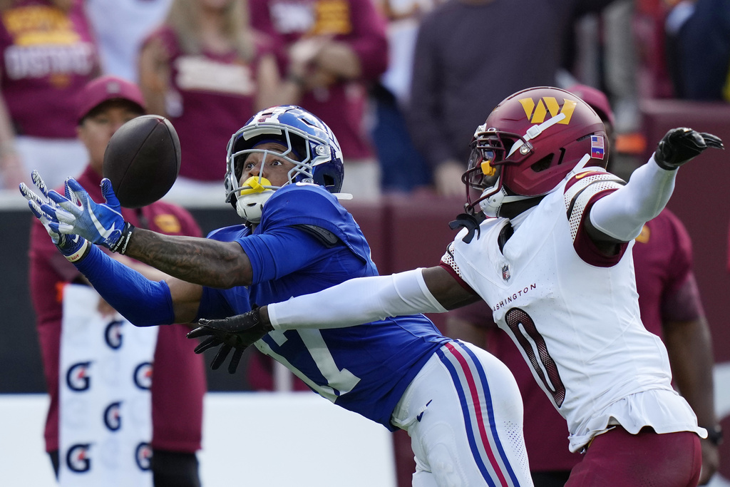 Washington Commanders cornerback Mike Sainristil (0) breaks up a pass intended for New York Giants wide receiver Wan'Dale Robinson (17) during the second half of an NFL football game, Sunday, Sept. 7, 2025, in Landover, Md. (AP Photo/Stephanie Scarbrough)