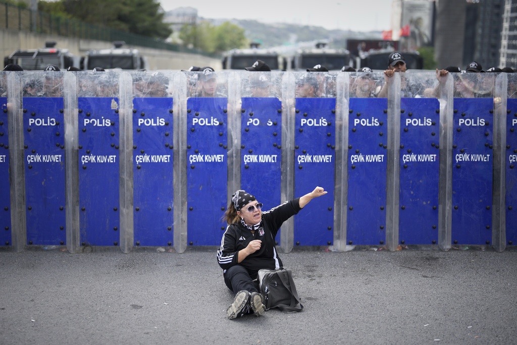 Riot police hold their shields as a supporter of Turkey's main opposition Republican People's Party (CHP) shouts slogans during a demonstration outside the party's headquarters in Istanbul, Monday, Sept. 8, 2025. (AP Photo/Francisco Seco)