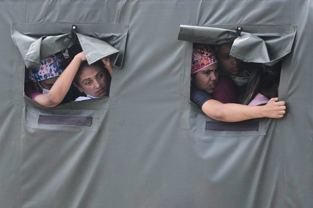 FILE - Health workers ride in a truck on their way to join earthquake relief efforts in La Guaira, Venezuela, June 28, 2026. (AP Photo/Fernando Vergara, File)