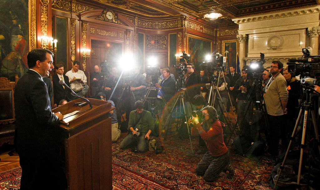 FILE - Wisconsin Gov. Scott Walker talks to the media Feb. 17, 2011, at the State Capitol in Madison, Wis., in response to several state Senators leaving the state to block his bill that would eliminate collective bargaining rights for many state workers. (AP Photo/Andy Manis, File)