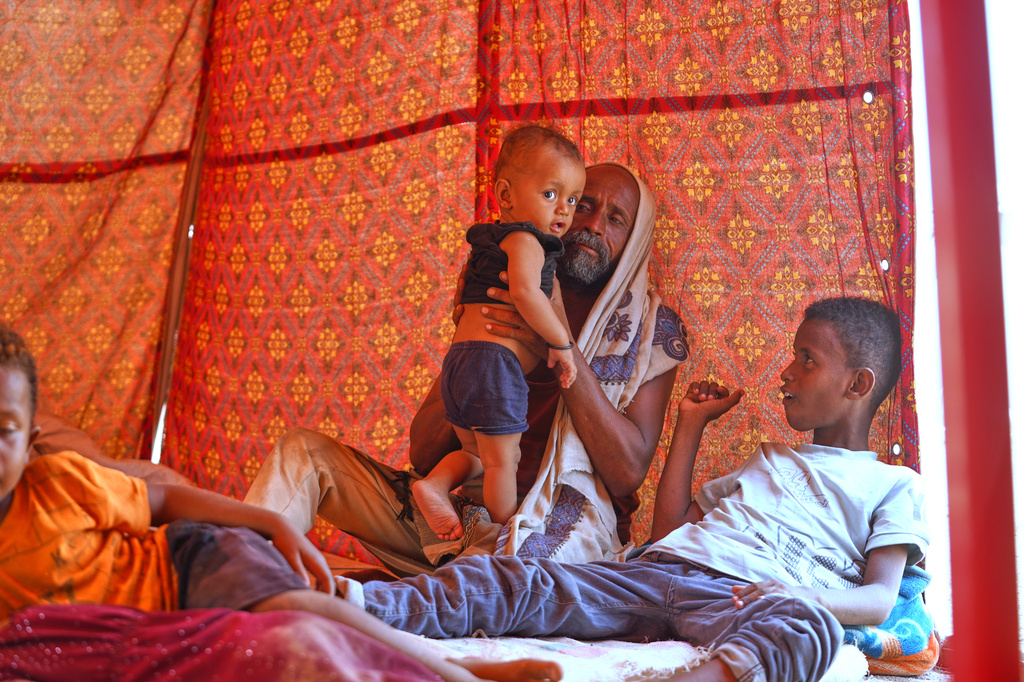 Displaced Yemenis sit at their tent at Al-Firdaws camp in Ras Imran, just outside Aden, Yemen, Monday, Sept. 14, 2026. (AP Photo/Abdulnasser Alseddik)