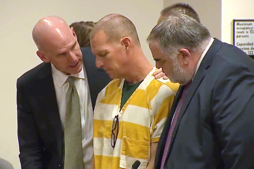 FILE - Lawyers console paramedic Peter Cichuniec after his sentence is read, March 1, 2024, in Brighton, Colo. (Colorado State Court via AP, Pool, File)