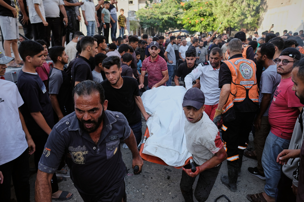 Palestinians carry a body from the site of an Israeli military strike in Gaza City, Sunday, Aug. 2, 2026. (AP Photo/Jehad Alshrafi)