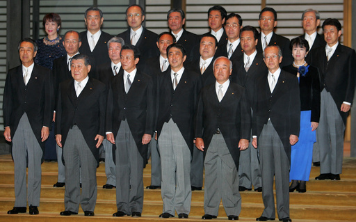 FILE - Newly-appointed Japanese Prime Minister Shinzo Abe, front row third from right, poses with his Cabinet members after an attestation ceremony for his Cabinet at the Imperial Palace in Tokyo, on Sept. 26, 2006. Front row from left: Education, Culture, Sports, Science and Technology Minister Bunmei Ibuki, Environment Minister Masatoshi Wakabayashi, Foreign Minister Taro Aso, Abe, Defense Agency Director General Fumio Kyuma and Finance Minister Koji Omi. Second row from left: Justice Minister Jinen Nagase, Health, Labor and Welfare Minister Hakuo Yanagisawa, Internal Affairs and Communications Minister Yoshihide Suga, Land, Infrastructure and Transport Minister Tetsuzo Fuyushiba and Economy, Trade and Industry Ministry Akira Amari and Economy and Banking Minister Hiroko Ota. Third row from left: Okinawa and Northern Territories, Innovation, Gender Equality and Food Safety Minister Sanae Takaichi, National Public Safety Commission Chairman Kensei Mizote, Administrative Reforms Minister Genichiro Sata, unidentified, unidentified, Toshikatsu Matsuoka, Yuji Yamamoto, unidentified and Chief Cabinet Secretary, also in charge of resolving North Korea's abductions of Japanese citizens Yasuhisa Shiozaki. (AP Photo/Itsuo Inouye, File) FILE - Newly-appointed Japanese Prime Minister Shinzo Abe, front row third from right, poses with his Cabinet members after an attestation ceremony for his Cabinet at the Imperial Palace in Tokyo, on Sept. 26, 2006. Front row from left: Education, Culture, Sports, Science and Technology Minister Bunmei Ibuki, Environment Minister Masatoshi Wakabayashi, Foreign Minister Taro Aso, Abe, Defense Agency Director General Fumio Kyuma and Finance Minister Koji Omi. Second row from left: Justice Minister Jinen Nagase, Health, Labor and Welfare Minister Hakuo Yanagisawa, Internal Affairs and Communications Minister Yoshihide Suga, Land, Infrastructure and Transport Minister Tetsuzo Fuyushiba and Economy, Trade and Industry Ministry Akira Amari and Economy and Banking Minister Hiroko Ota. Third row from left: Okinawa and Northern Territories, Innovation, Gender Equality and Food Safety Minister Sanae Takaichi, National Public Safety Commission Chairman Kensei Mizote, Administrative Reforms Minister Genichiro Sata, unidentified, unidentified, Toshikatsu Matsuoka, Yuji Yamamoto, unidentified and Chief Cabinet Secretary, also in charge of resolving North Korea's abductions of Japanese citizens Yasuhisa Shiozaki. (AP Photo/Itsuo Inouye, File)