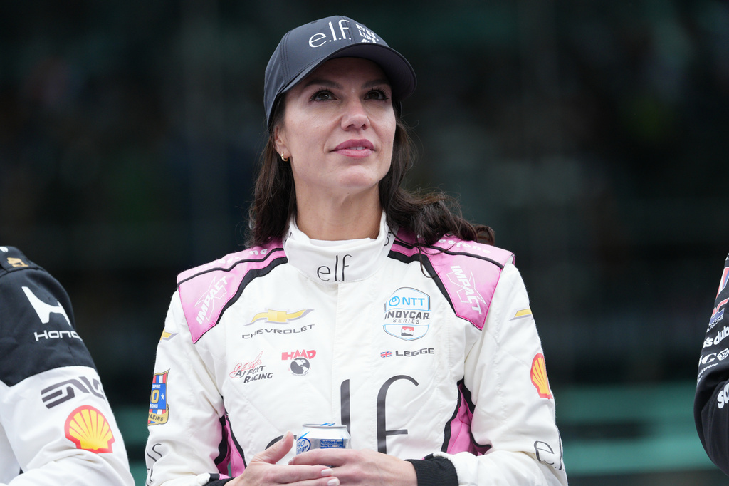 Katherine Legge, of Great Britain, looks at the crowd during driver introductions before the start of the Indianapolis 500 auto race at the Indianapolis Motor Speedway, Sunday, May 24, 2026 in Indianapolis. (AP Photo/AJ Mast)