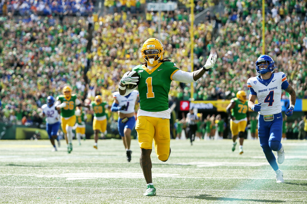 Oregon wide receiver Dakorien Moore (1) celebrates his touchdown run during the second half of an NCAA college football game against Boise State, Saturday, Sept. 5, 2026, in Eugene, Ore. (AP Photo/Lydia Ely)