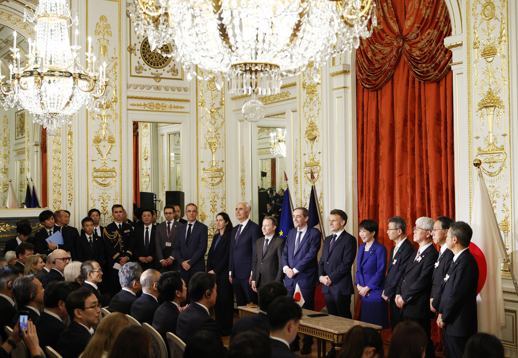 Japanese Prime Minister Sanae Takaichi, center right, and French President Emmanuel Macron, center left, pose for a group photo during signing ceremony at the Akasaka Palace state guest house in Tokyo Wednesday, April 1, 2026. (Franck Robichon/Pool Photo via AP)