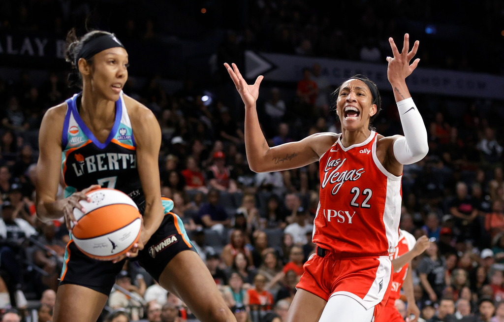 Las Vegas Aces center A'ja Wilson (22) reacts after missing a basket as New York Liberty guard Rebekah Gardner (7) makes the rebound during the first half of an WNBA basketball game Thursday, July 30, 2026, in Las Vegas. (Steve Marcus/Las Vegas Sun via AP)