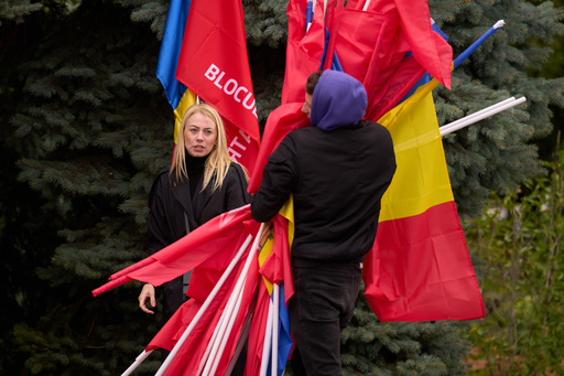 Activists gather flags at the end of a rally of the Russia-friendly Patriotic Electoral Bloc in Chisinau, Moldova, Thursday, Sept. 25, 2025, ahead of parliamentary elections taking place on Sept. 28. (AP Photo/Vadim Ghirda) Activists gather flags at the end of a rally of the Russia-friendly Patriotic Electoral Bloc in Chisinau, Moldova, Thursday, Sept. 25, 2025, ahead of parliamentary elections taking place on Sept. 28. (AP Photo/Vadim Ghirda)