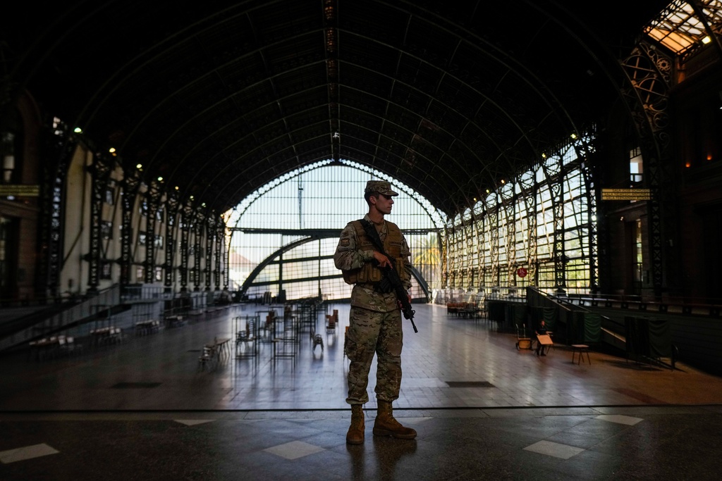 A soldier guards the old Mapocho train station, now a cultural center, that will be used as a polling station for the general election in Santiago, Chile, Friday, Nov. 14, 2025. (AP Photo/Esteban Felix)