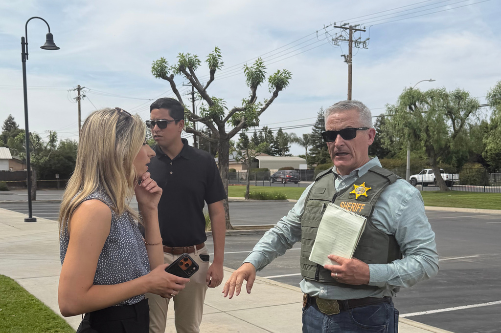 Tulare County Sheriff Mike Boudreaux, right, speaks to media after a sheriff's deputy was shot and killed Thursday, April 9, 2026, in Porterville, Calif. (Tulare County Sheriff's Office via AP)