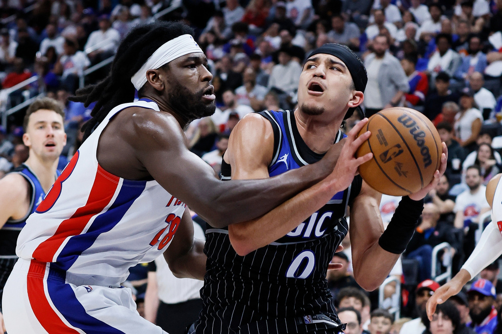 Orlando Magic guard Anthony Black (0) is fouled by Detroit Pistons forward Isaiah Stewart (28) while driving to the basket during the second half in Game 2 of a first-round NBA basketball playoffs series Wednesday, April 22, 2026, in Detroit. (AP Photo/Duane Burleson)