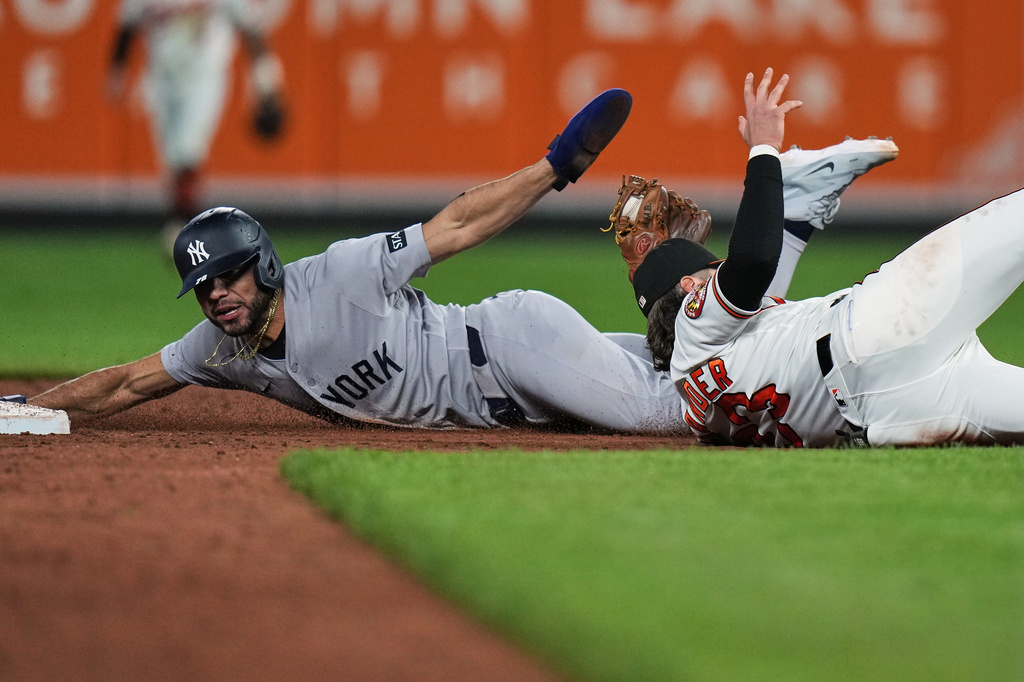 New York Yankees' José Caballero, left, is caught by Baltimore Orioles second baseman Blaze Alexander, right, while trying to steal second base during the ninth inning of a baseball game, Monday, May 11, 2026, in Baltimore. (AP Photo/Stephanie Scarbrough)