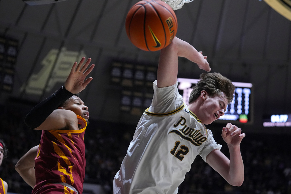 Purdue center Daniel Jacobsen (12) looses the ball after being fouled by Iowa State forward Joshua Jefferson (5) during the second half of an NCAA college basketball game in West Lafayette, Ind., Saturday, Dec. 6, 2025. (AP Photo/Michael Conroy)