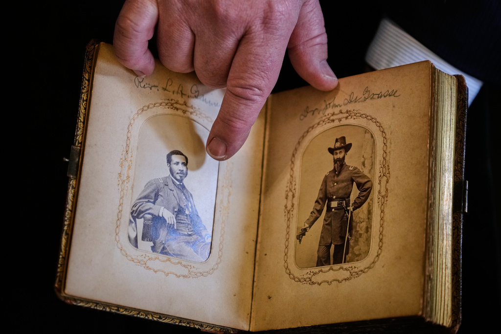Portraits of Mass. Rep. Charles Lewis Mitchell, left, and Dr. John V. de Grasse are shown from an photograph album from the personal collection of anti-slavery activist Harriet Hayden, which was printed in the 1860's, at the Boston Athenaeum, Thursday, Oct. 9, 2025, in Boston. (AP Photo/Charles Krupa)