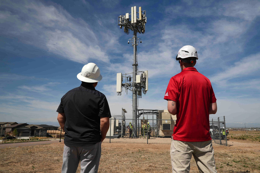 Workers observe a tower where Pano AI cameras are installed for detecting wildfires Monday, April 20, 2026, in Aurora, Colo. (AP photo/Brittany Peterson)