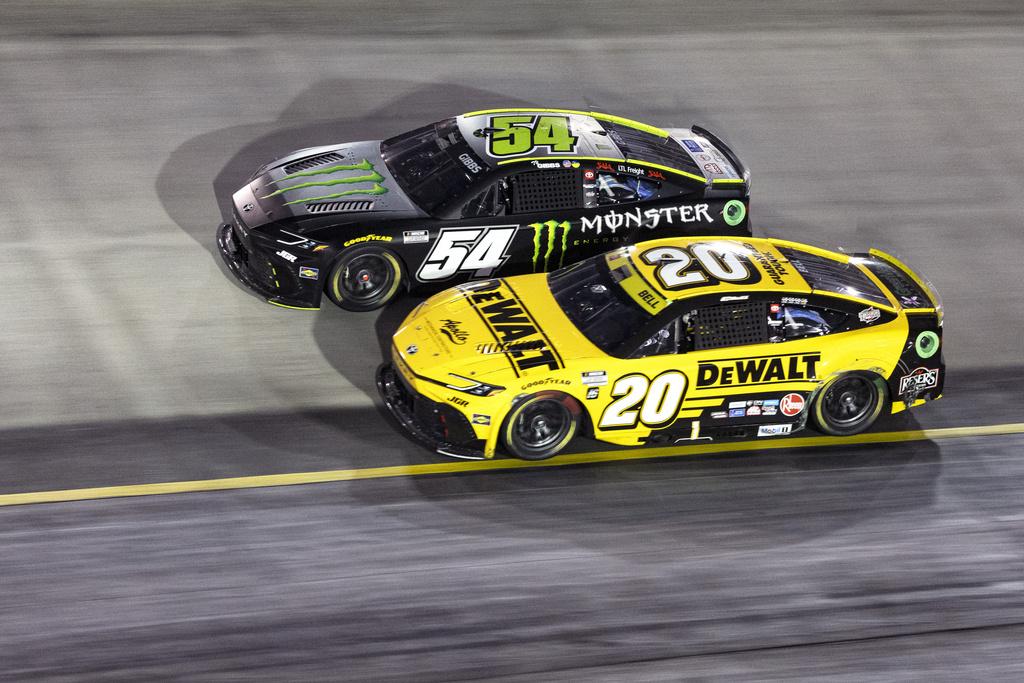 Christopher Bell (20) battles with Ty Gibbs (54) during a NASCAR Cup Series auto race, Saturday, Sept. 13, 2025, in Bristol, Tenn. (AP Photo/Wade Payne)
