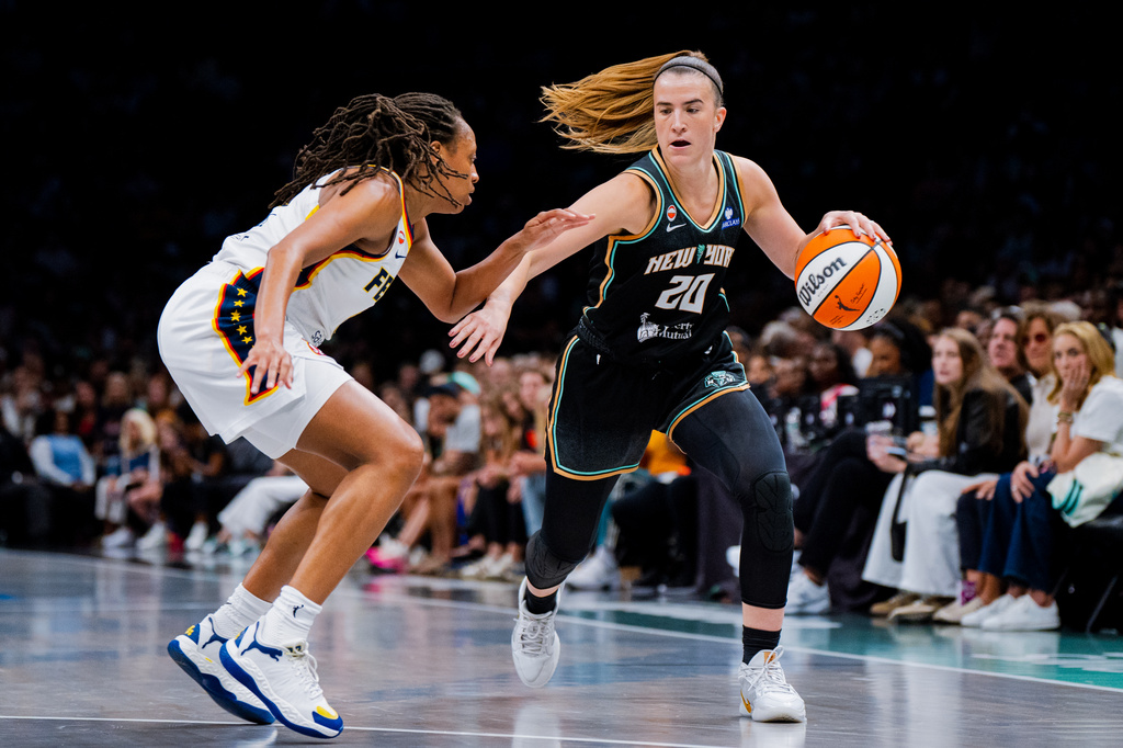 New York Liberty guard Sabrina Ionescu (20) dribbles toward the basket during the first half of a WNBA basketball game against the Indiana Fever, Saturday, Aug. 22, 2026, in New York. (AP Photo/Angelina Katsanis)