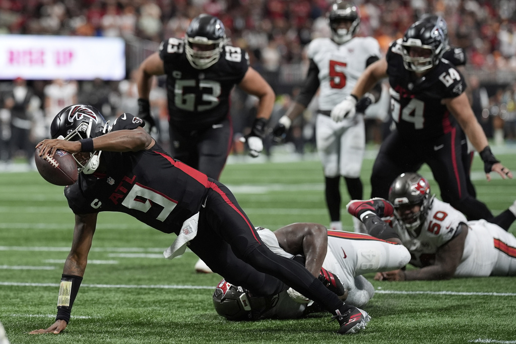Atlanta Falcons quarterback Michael Penix Jr. (9) scores a touchdown during the second half of an NFL football game against the Tampa Bay Buccaneers, Sunday, Sept. 7, 2025, in Atlanta. (AP Photo/Mike Stewart)
