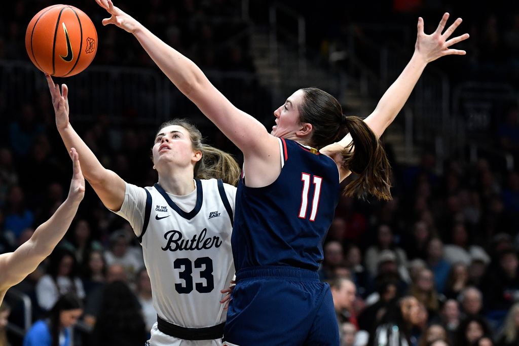 UConn guard Allie Ziebell (11) attempts to block the shot of Butler guard Addison Baxter (33) during the first half of an NCAA college basketball game in Indianapolis, Sunday, Dec. 28, 2025. (AP Photo/Timothy D. Easley)