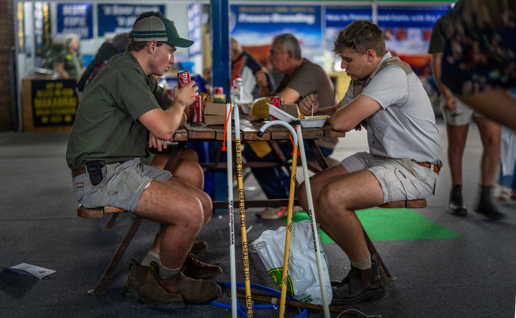 FILE - Farmers sit for lunch at the Nampo agricultural fair, one of the largest in the southern hemisphere, near Bothaville, South Africa, May 15, 2025. (AP Photo/Jerome Delay, File)