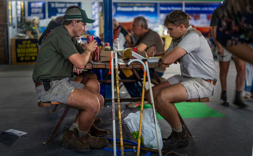 FILE - Farmers sit for lunch at the Nampo agricultural fair, one of the largest in the southern hemisphere, near Bothaville, South Africa, May 15, 2025. (AP Photo/Jerome Delay, File) FILE - Farmers sit for lunch at the Nampo agricultural fair, one of the largest in the southern hemisphere, near Bothaville, South Africa, May 15, 2025. (AP Photo/Jerome Delay, File)