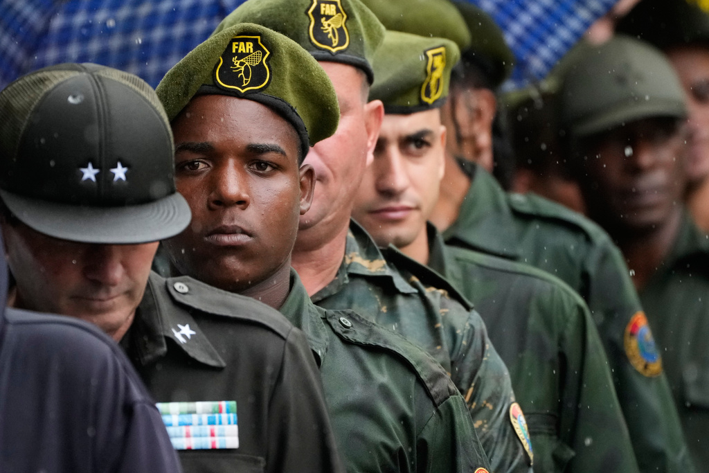 Military members line up outside the Ministry of the Revolutionary Armed Forces where the urns containing the remains of Cuban officers, killed during the U.S. operation in Venezuela that captured President Nicolas Maduro, are on display in Havana, Cuba, Thursday, Jan. 15, 2026. (AP Photo/Ramon Espinosa)