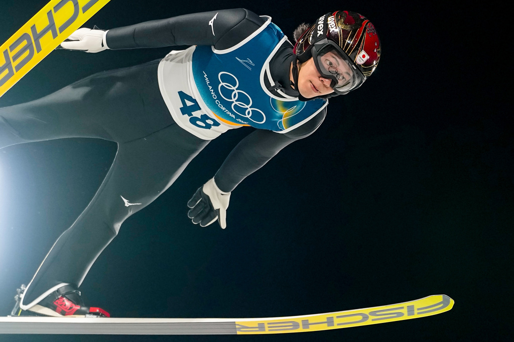 Ren Nikaido, of Japan, soars through the air during his first round jump of the ski jumping men's normal hill individual at the 2026 Winter Olympics, in Predazzo, Italy, Monday, Feb. 9, 2026. (AP Photo/Matthias Schrader)