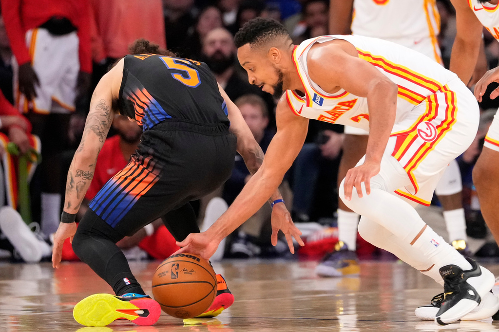 Atlanta Hawks guard CJ McCollum, right, attempts to steal the ball from New York Knicks guard Jose Alvarado (5) during the second half in Game 2 of a first-round NBA playoffs basketball series, Monday, April 20, 2026, in New York. (AP Photo/Yuki Iwamura)